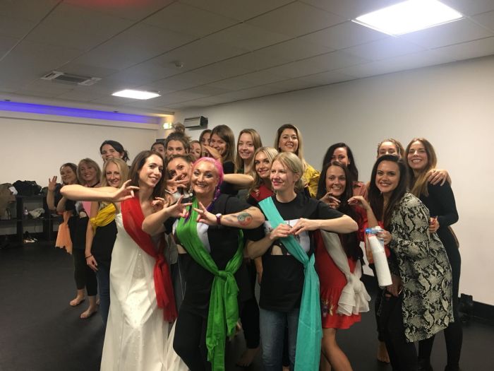 Bollywood themed hen party Manchester - bride and hens in traditional Indian costumes doing graceful moves