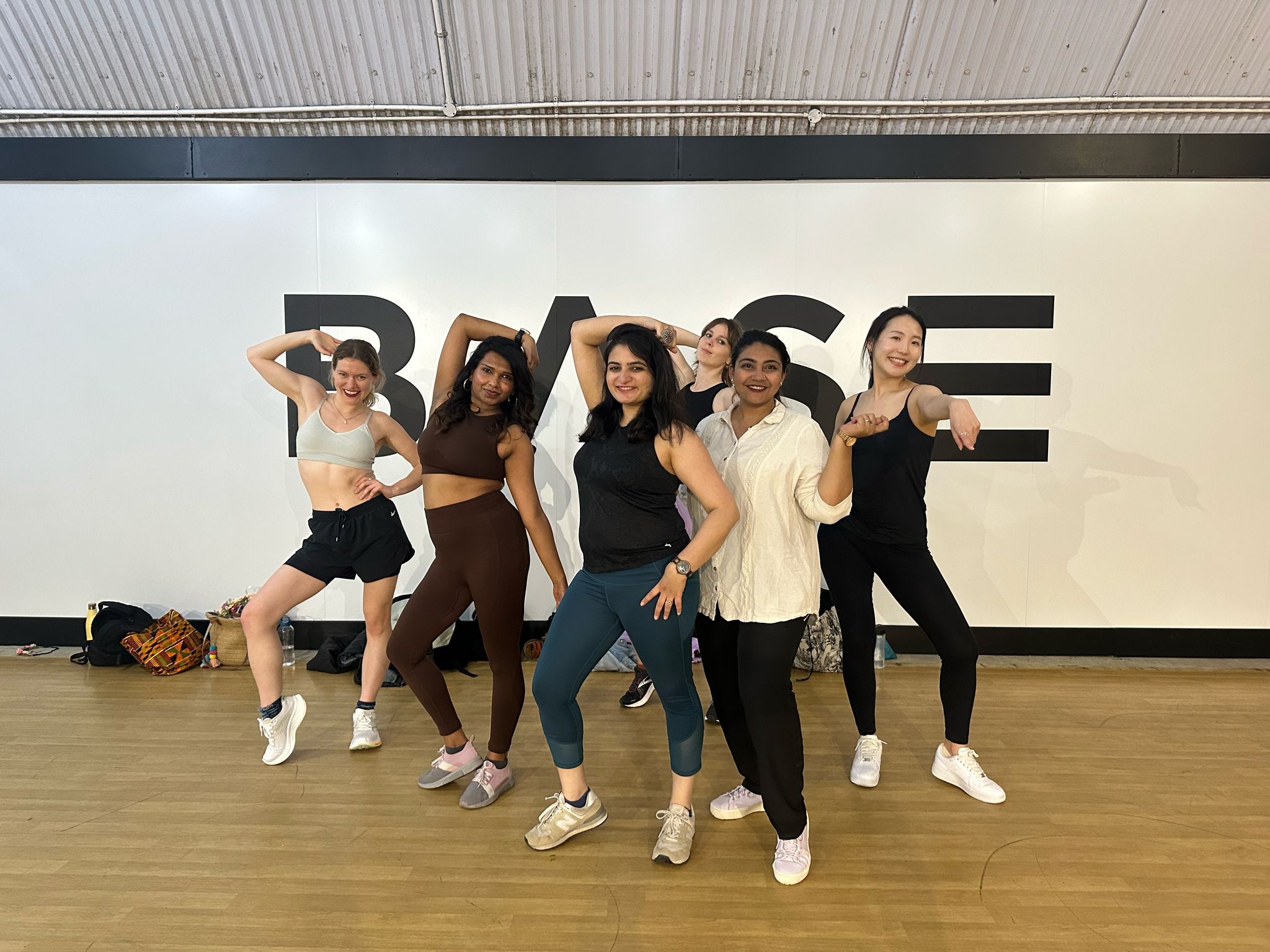Bollywood hen party dance class Manchester - group learning traditional Indian dance moves in colorful saris
