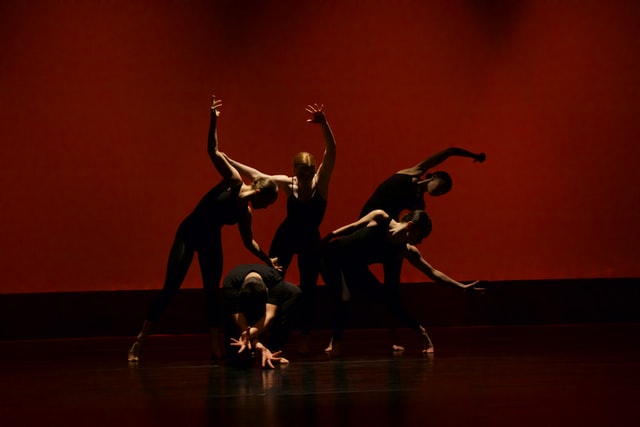 Professional contemporary dance class in Manchester city centre studio with dancers practicing expressive floor work and fluid movement techniques
