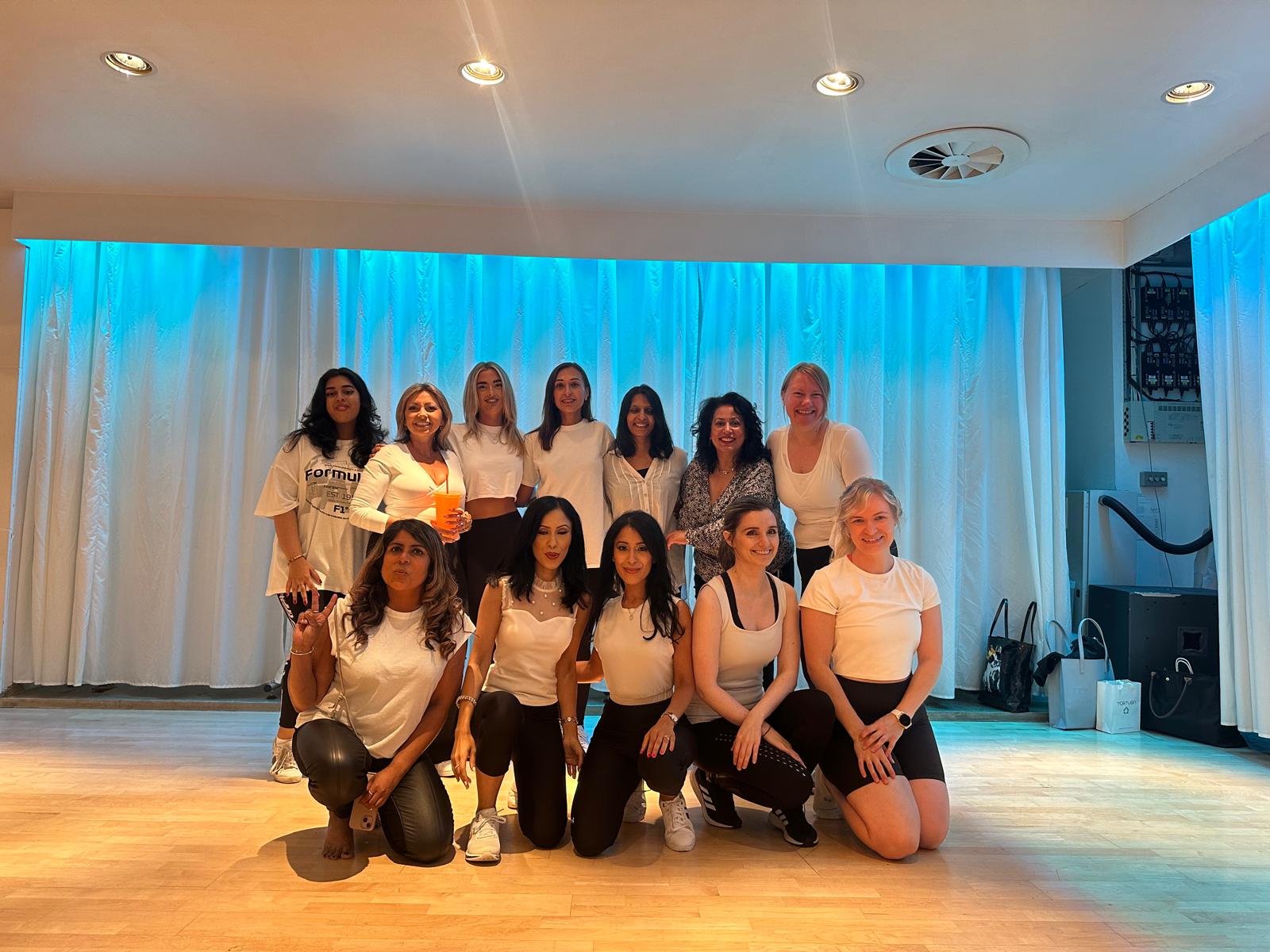 Professional K-Pop dance class in Manchester city centre studio with dancers practicing Korean pop choreography and synchronized formations on sprung floors